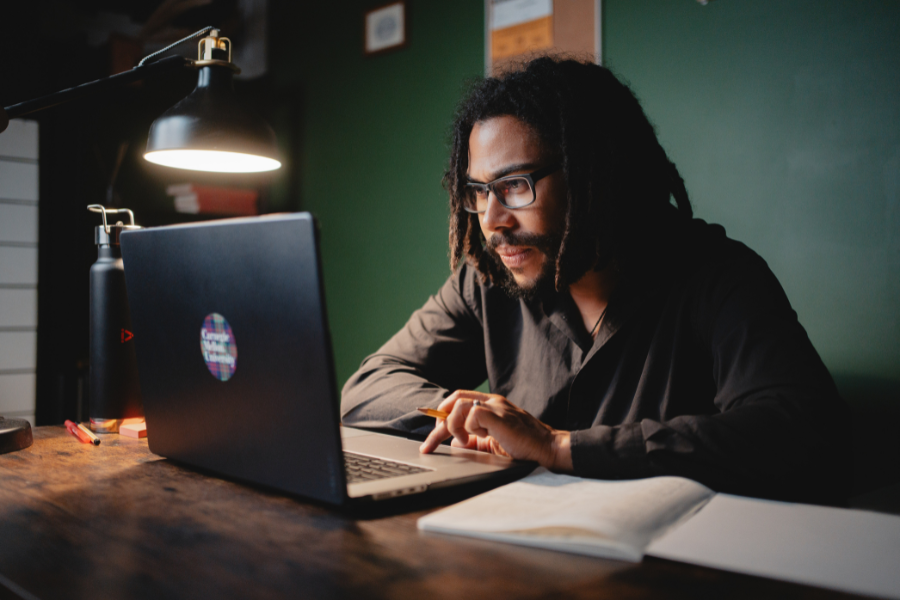 Student learning at a desk on his computer