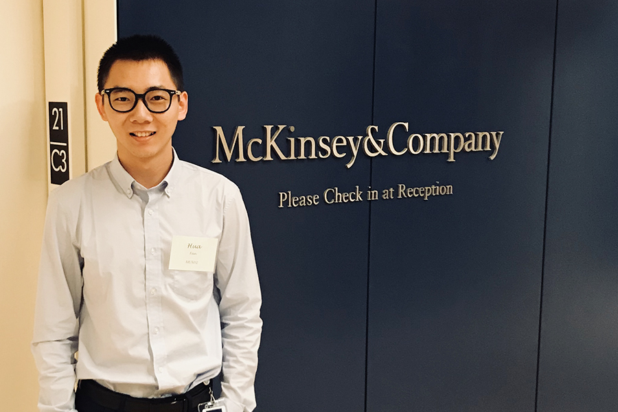 Hua Fan stands before the McKinsey Office