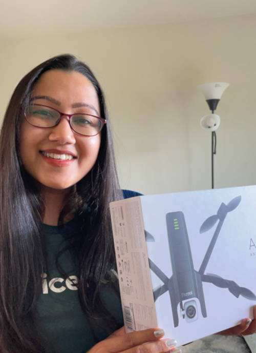 Madhu holding a drone she won in an internship competition