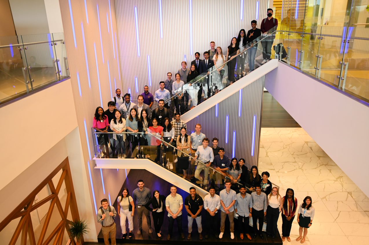 student abhishek iyer is photographed on a staircase with his cohort of HP interns.