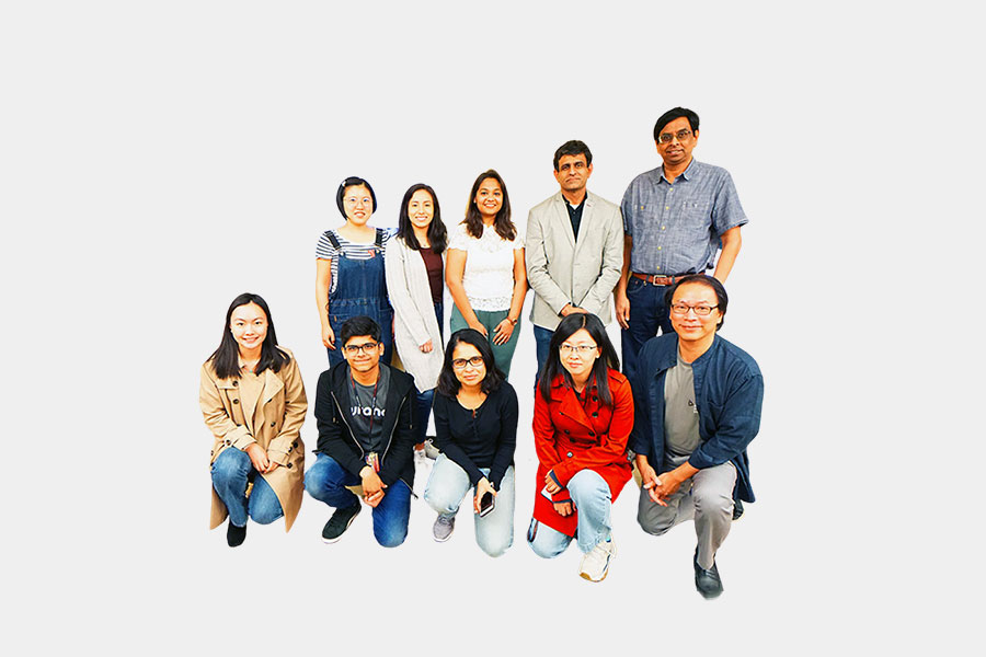 a group of students poses for a photo with Professor Karim Shaikh