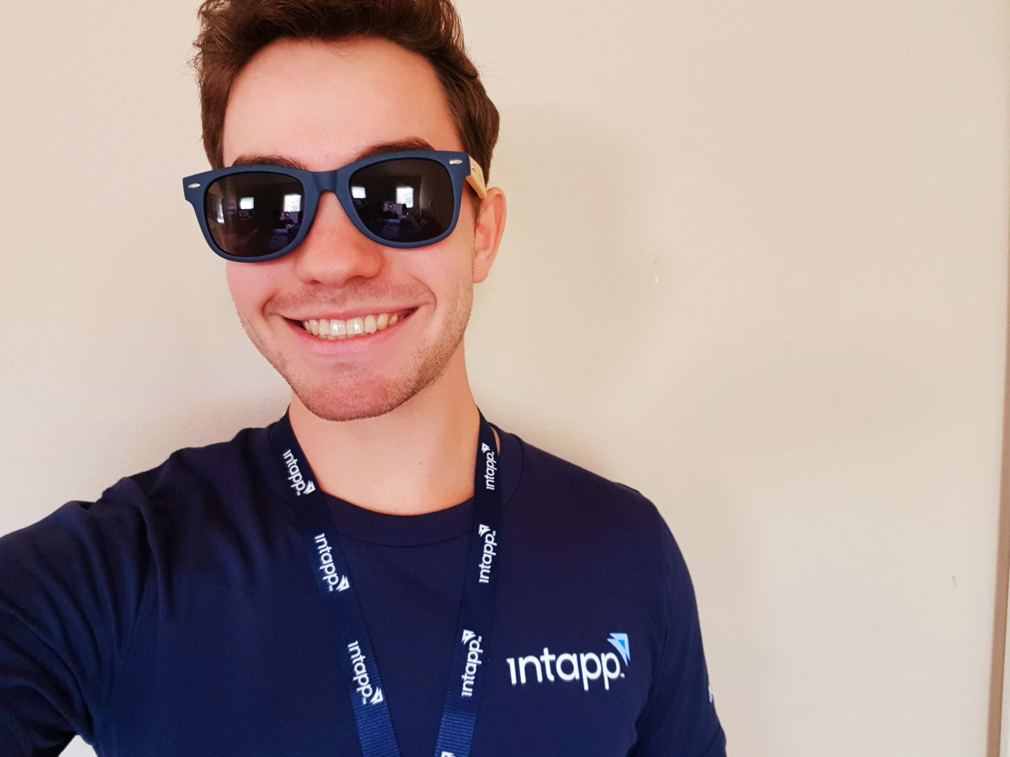 student jonathan gelfman poses wearing a branded t-shirt and sunglasses from his company, Intapp