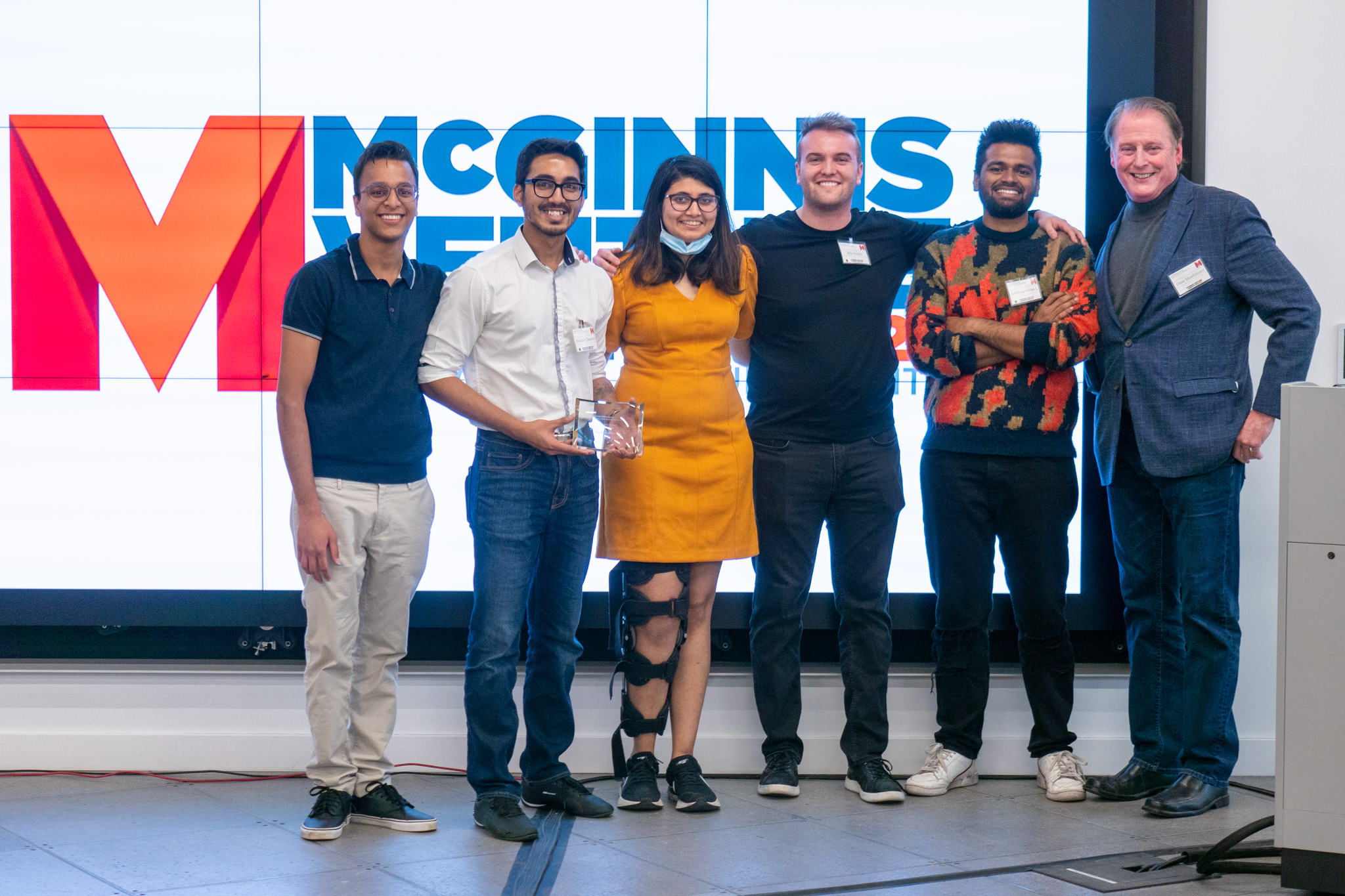 students posing with award