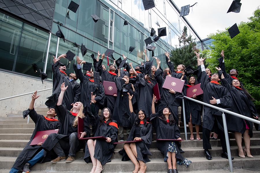 students throwing graduation caps