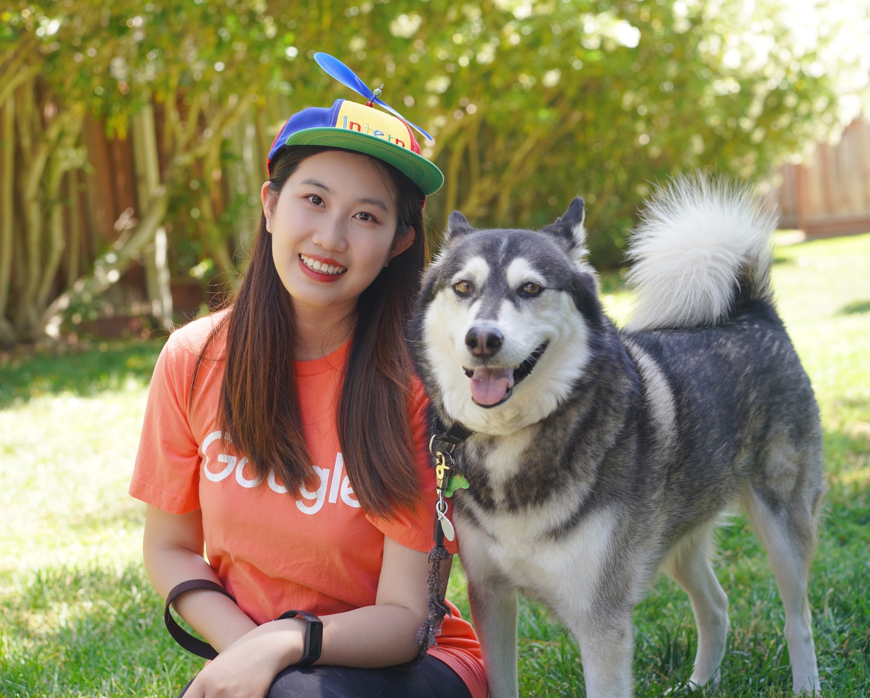 student yiyuan zhu poses for a photo with her pet husky