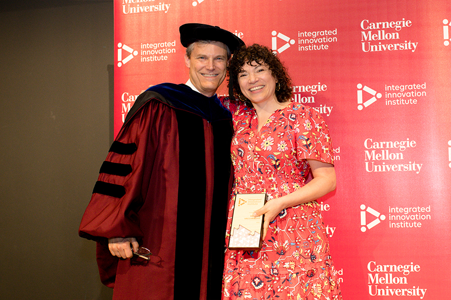 iii Director Peter Boatwright presents Minette Vaccariello with the Alumni Changemaker Award