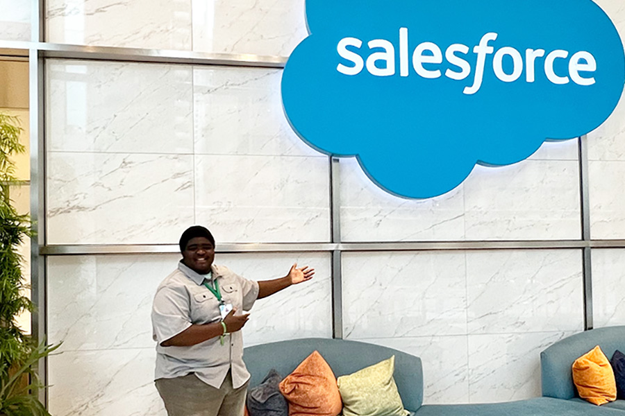 Funbi posing in front of the SalesForce sign