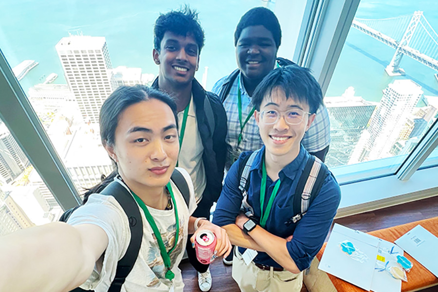 group of interns taking a selfie on top of the tower