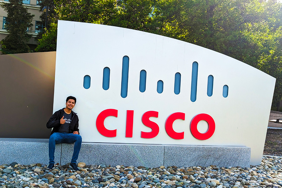 Utkarsh poses by the Cisco sign