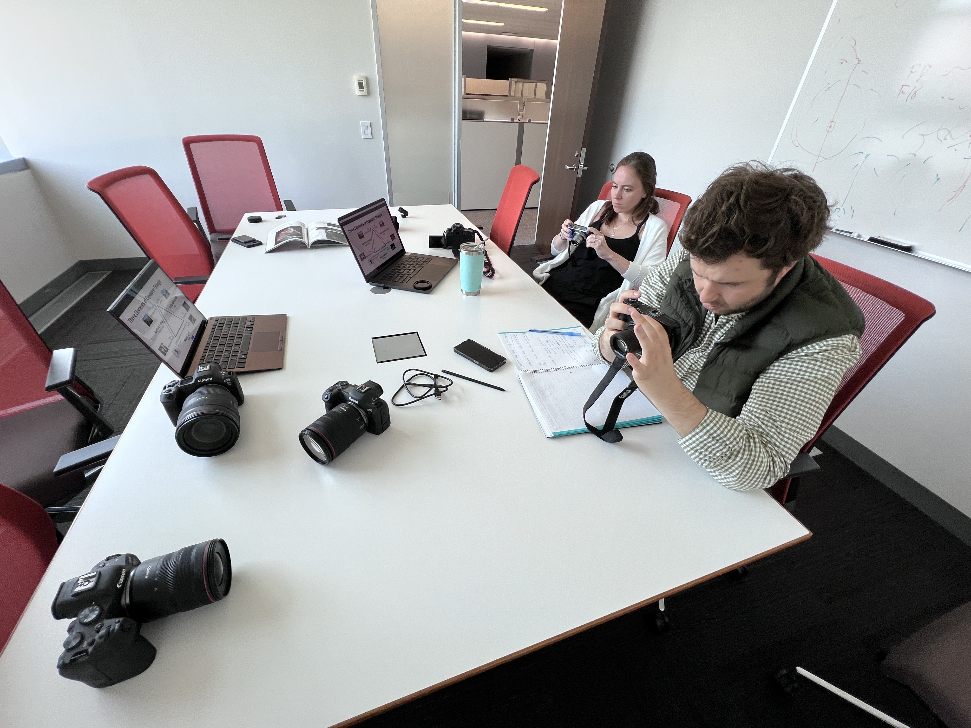 Gabriel looking at camera features at his Canon internship