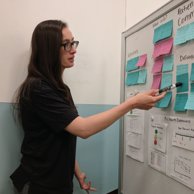 a cmu student going over notes on a board