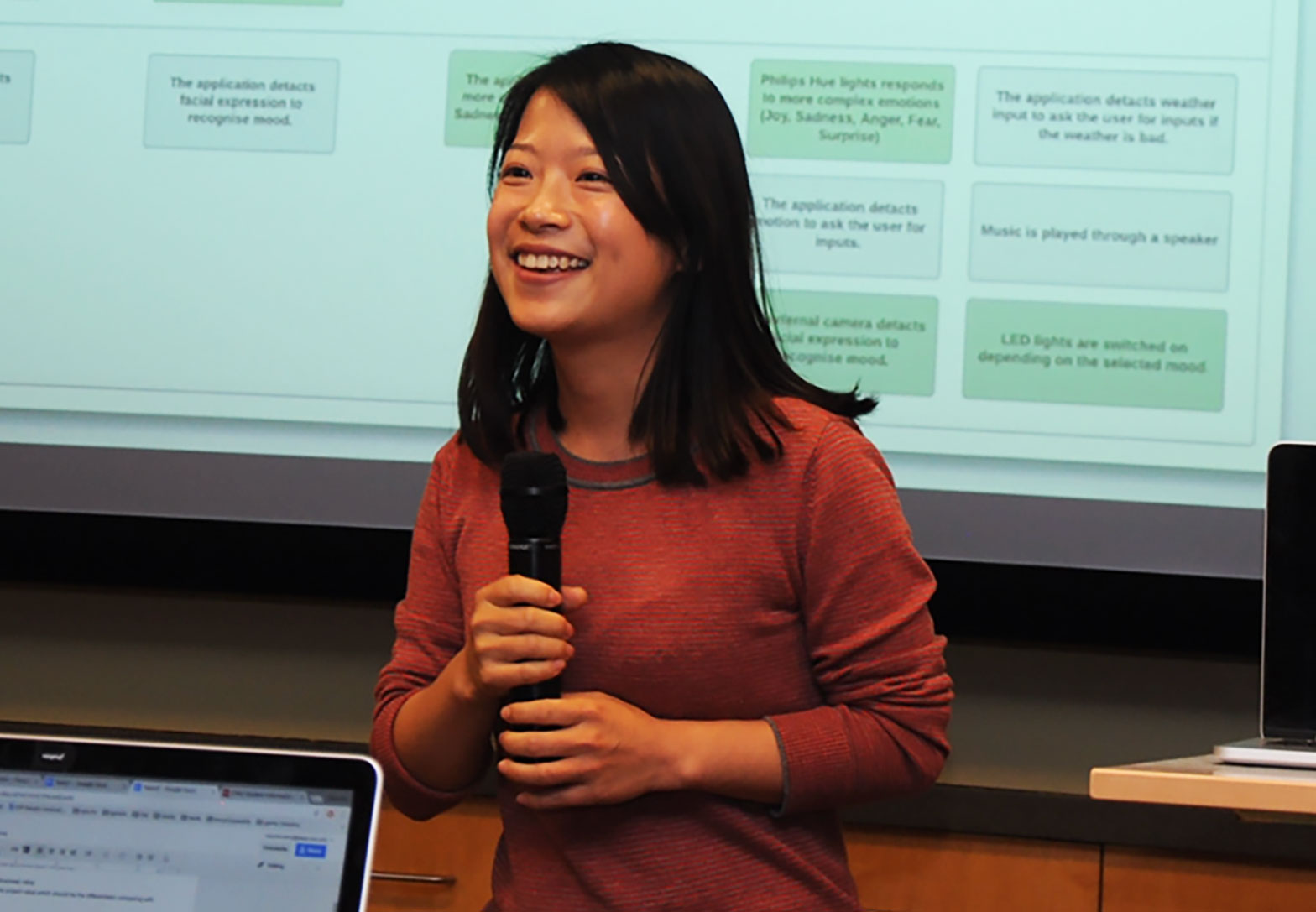 student in front of class presenting to peers