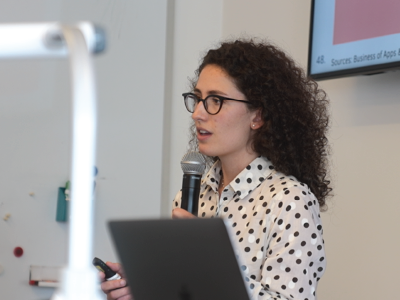 woman speaking through a microphone