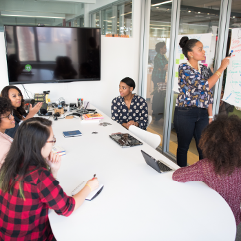 a group of people having a meeting in a conference room