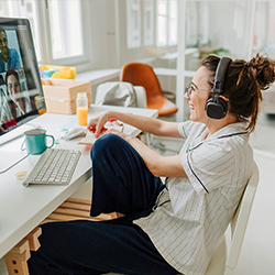 woman at desk on zoom on a computer