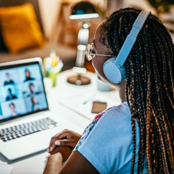 image of a female student sitting at computer on zoom working on earning an innovation certificate in new product management