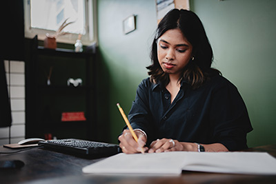 female student working on a project for the masters in innovation online degree program