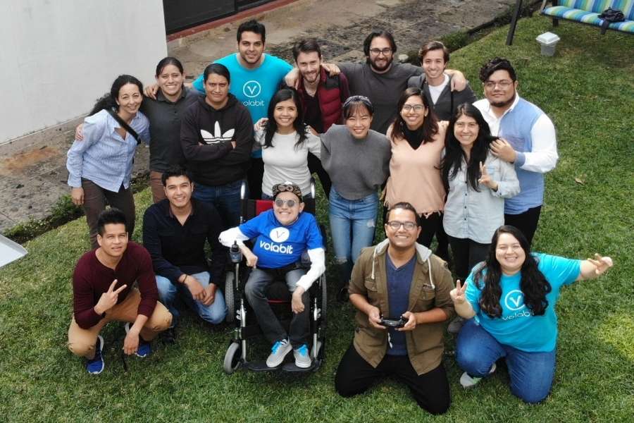 Hannah and Tomas pose outside with their team at Volabit and Mifiel