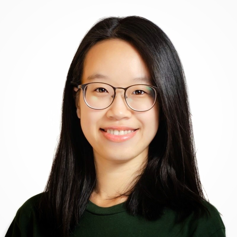 A brunette woman with glasses in a green shirt