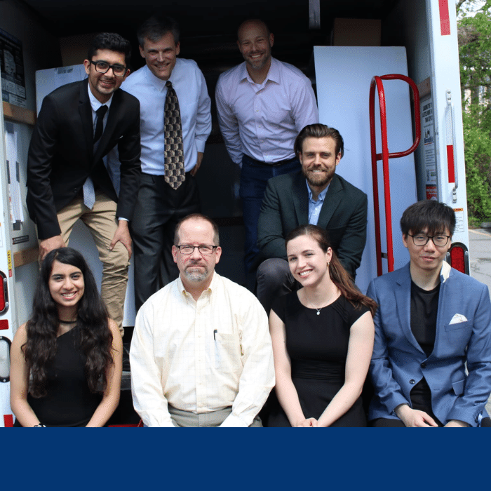 The Trucklite Capstone team, composed of 5 students, pose in the back of the track with the project sponsor and two faculty members.e in the back of a truck with their capstone sponsor - Trucklite - and two faculty members.