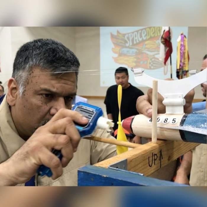 Suterwala builds a wooden plane during a Cub Scouts meeting