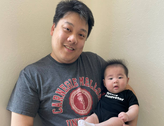 Clarence Tam with his baby