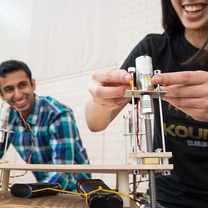 two students working on an engineering project