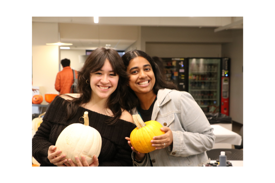 Students posing with painted pumpkins