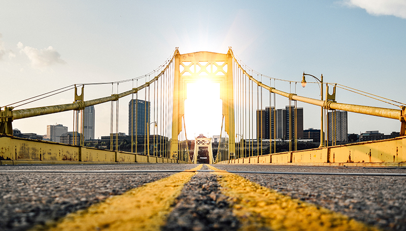 Pittsburgh yellow bridge with sunrise.