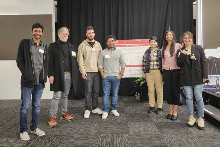 Students standing with their poster