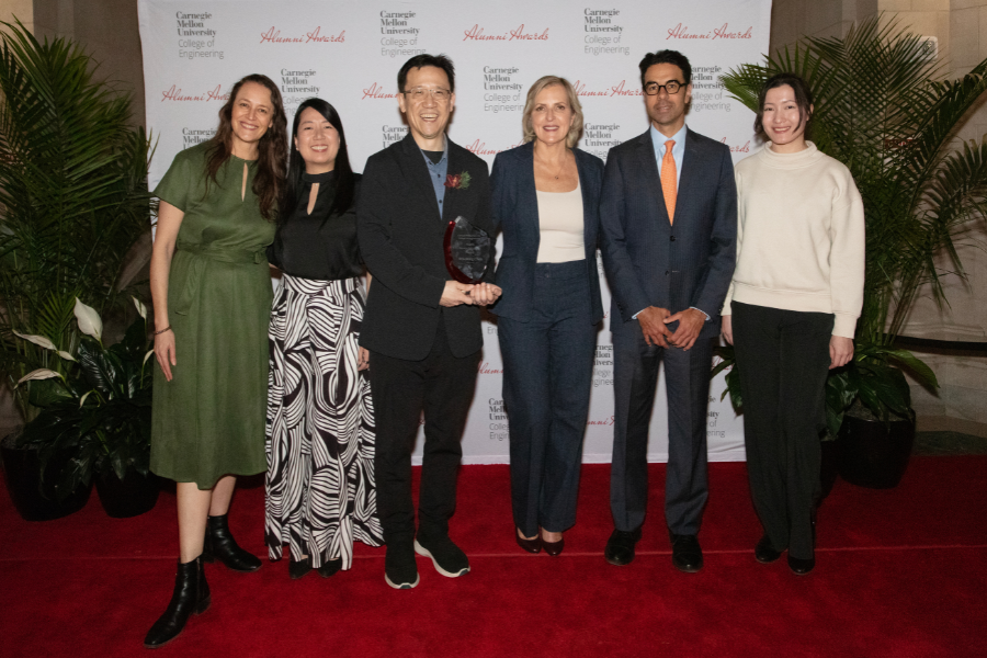 A group of people posing for a picture at an awards ceremony