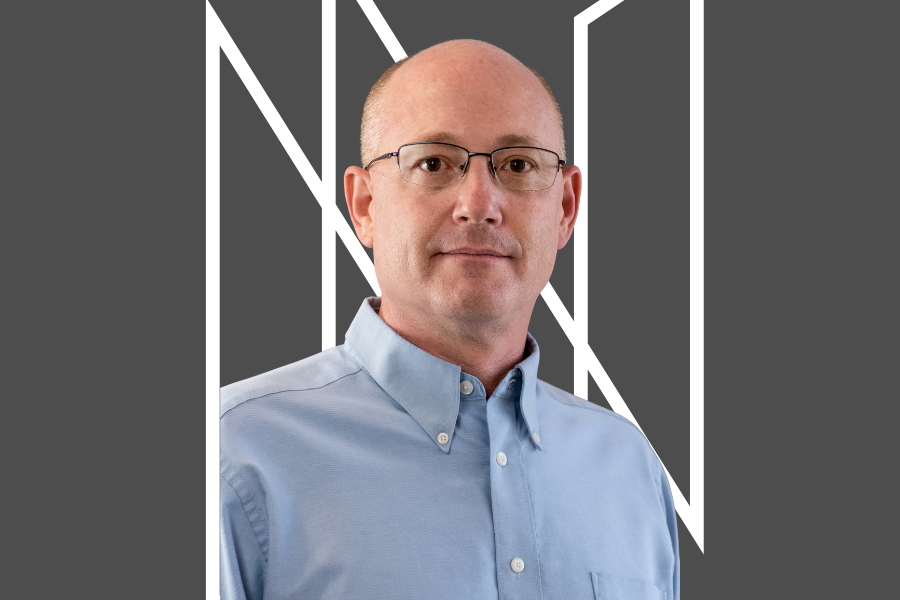 Dr. Quinn Jacobson on a dark grey background