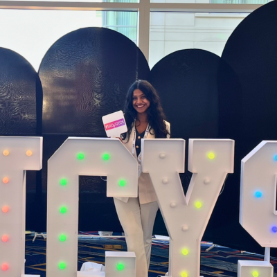 Savadatti posing for a picture at the WiCyS conference
