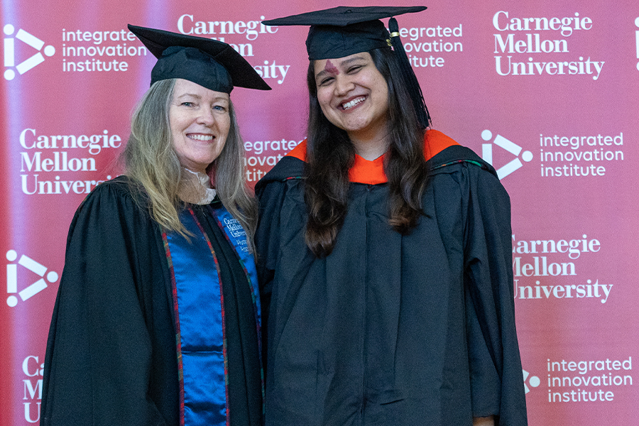 a student poses with Program Director Gladys Mercier