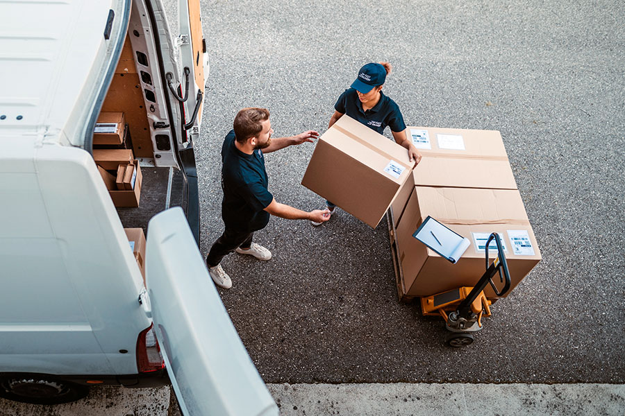 people unloading boxes from delivery truck