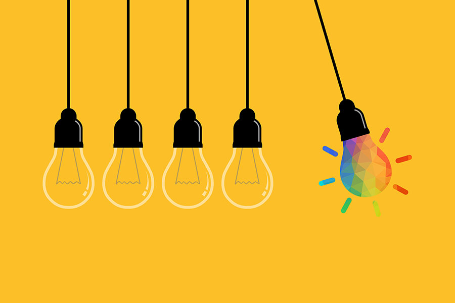 Illustration - light bulbs in perpetual motion against a yellow background with last light bulb lit up with rainbow idea inside