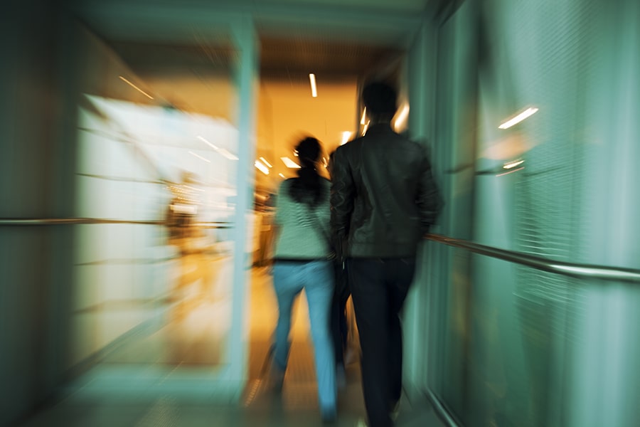 Man following someone into building