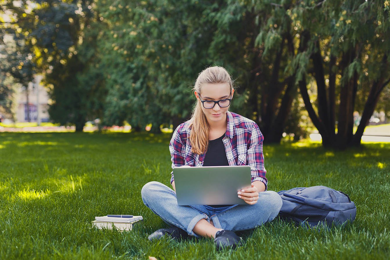 Girl on computer outside