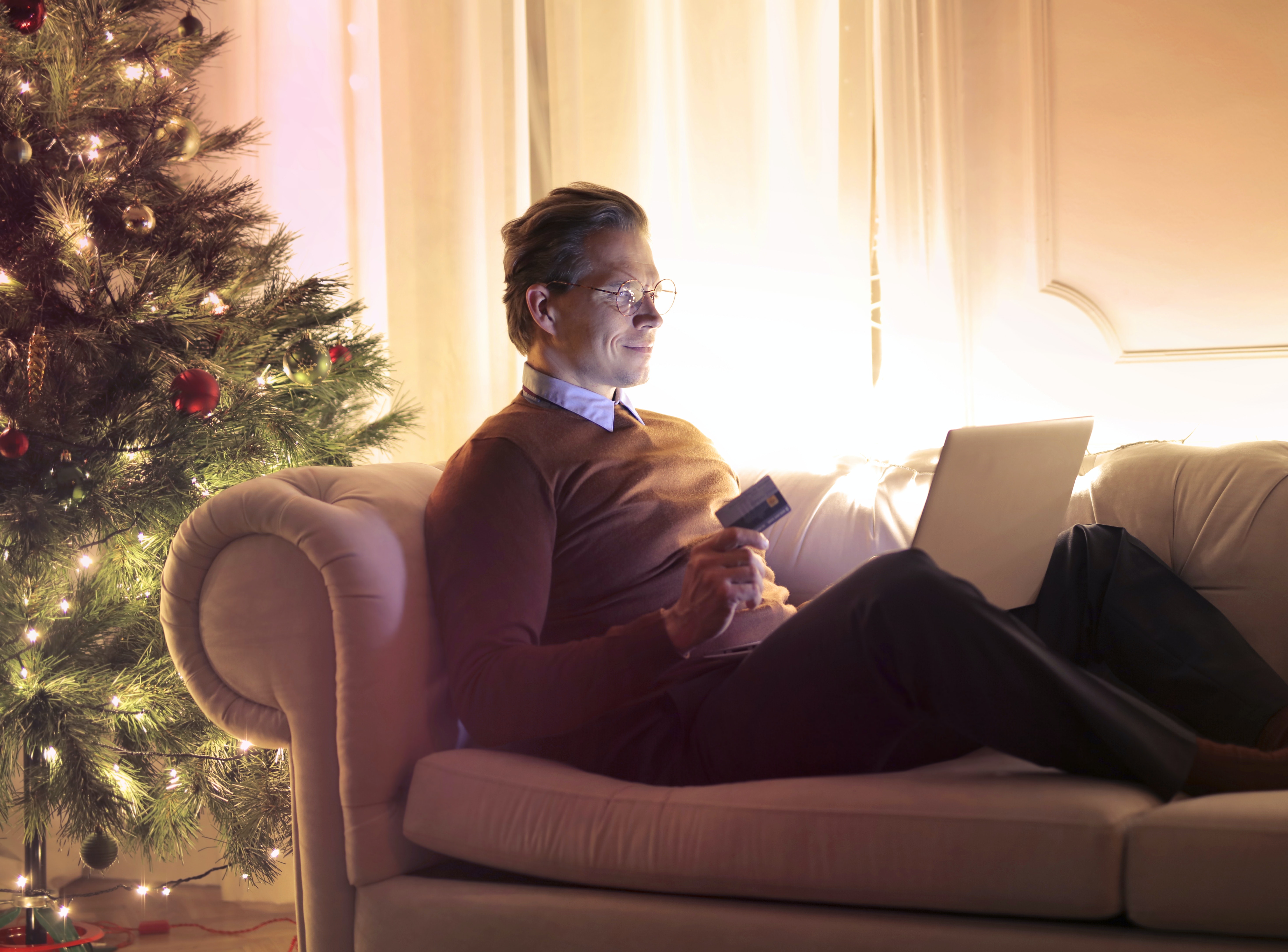 Image of man holiday shopping from home