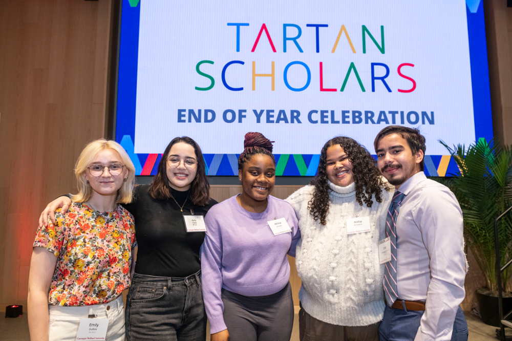 five students with their arms around each other at the Tartan Scholars Celebration event