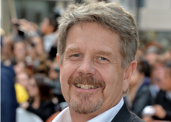 John Wells' headshot.