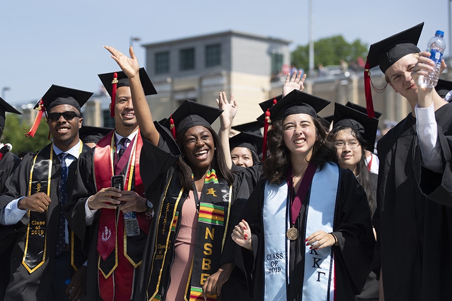 A photo of excited students at their commencement ceremony