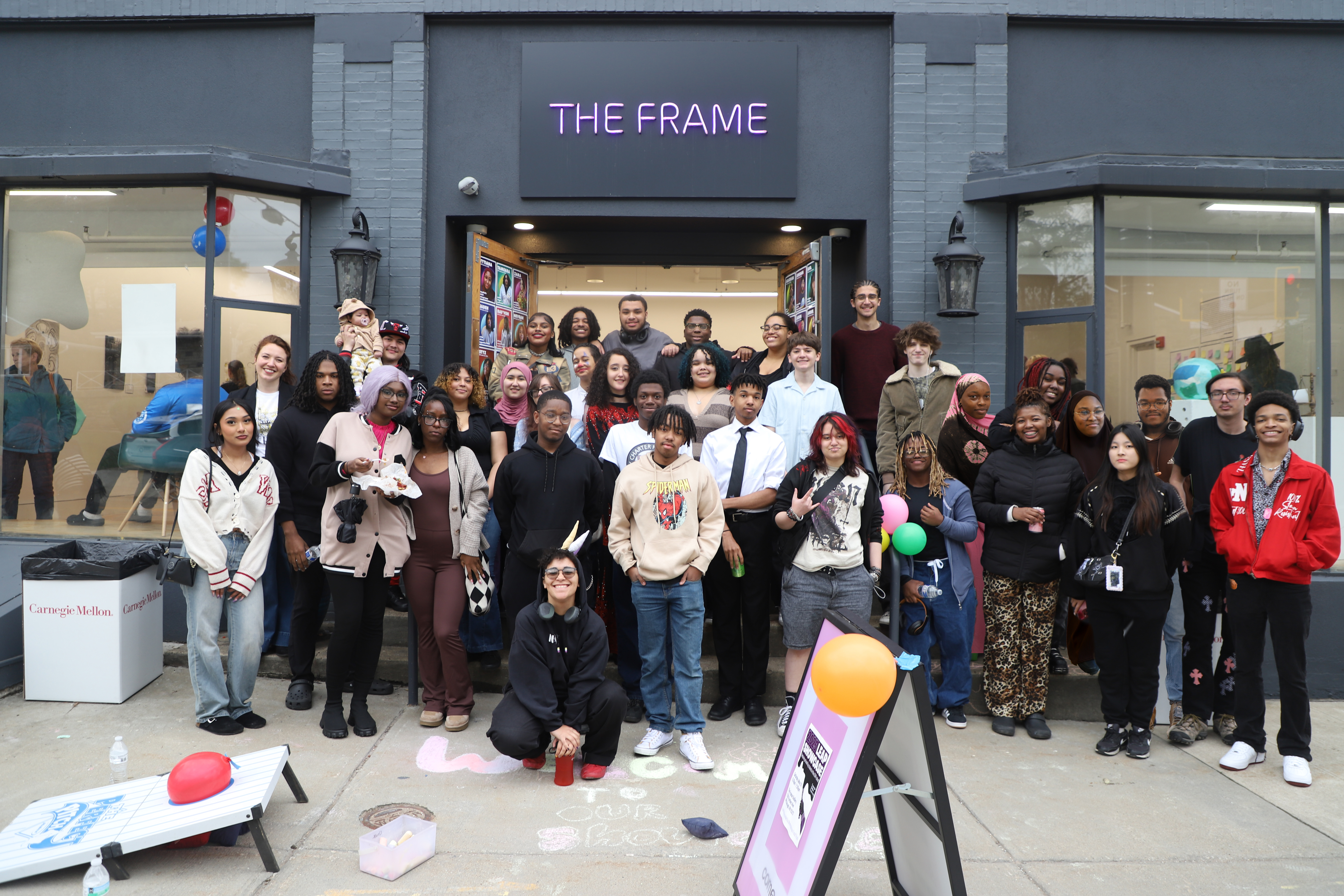 LEAP students and their teacher posing together outside of The Frame Gallery during their 2025 Showcase celebration. 
