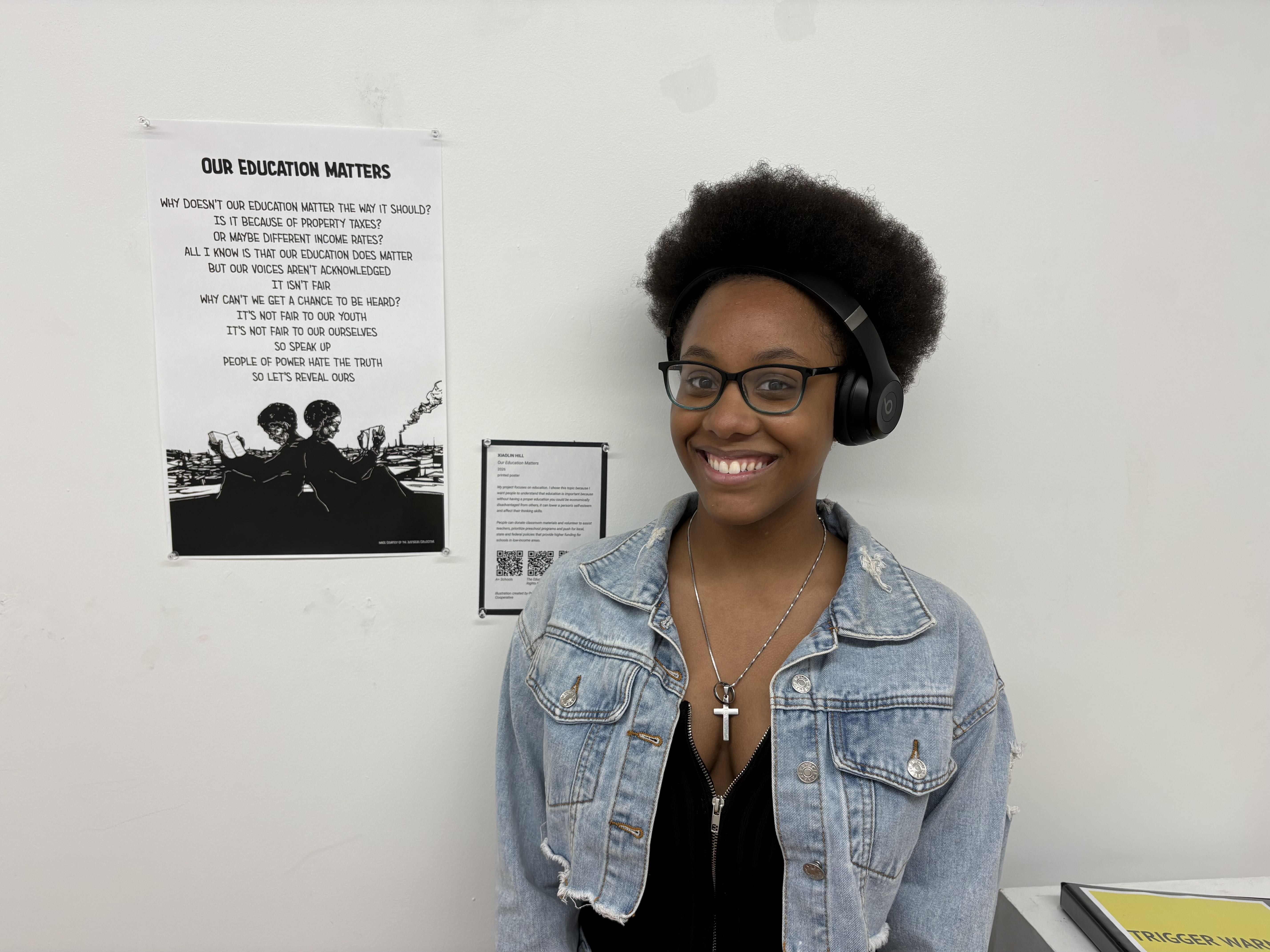 Student standing next to a printed poem.