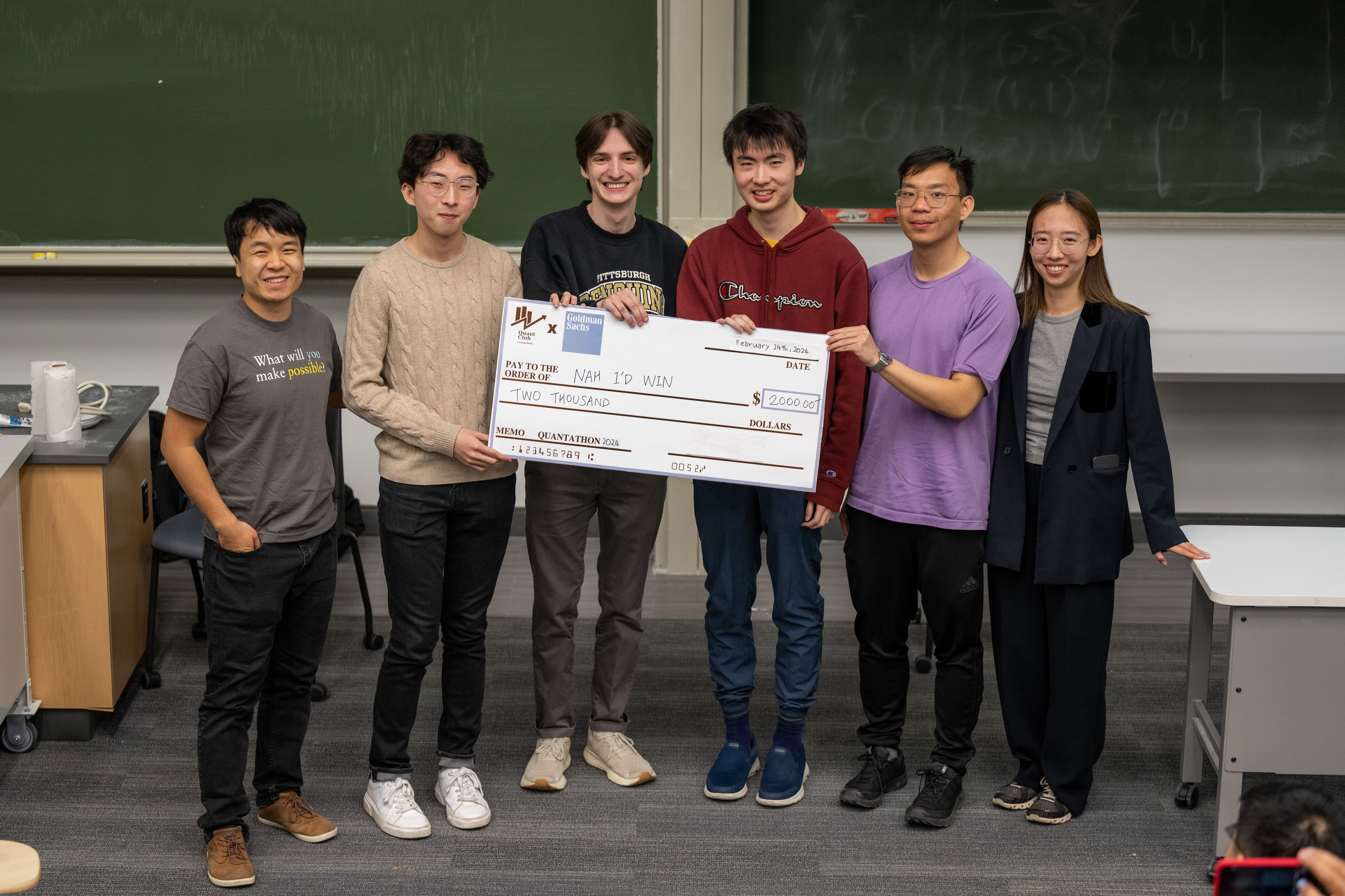 Lucas Zhang, Michael Duncan, James Yang and David Tang hold a giant check