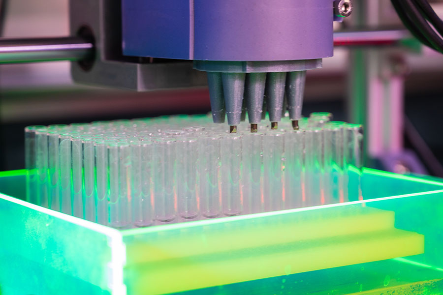 Fluorescent green test tubes in a lab.