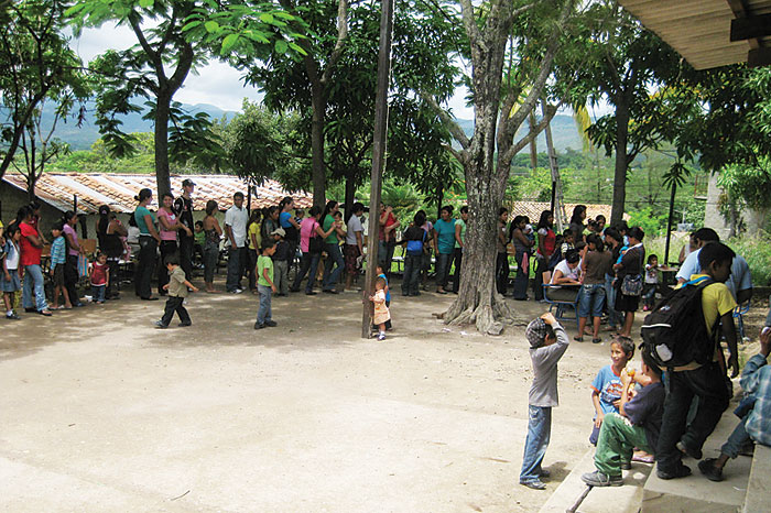 photo of villagers waiting for care