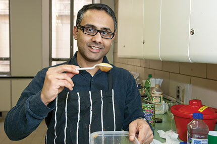 Photo of Das with upside-down spoon holding soy sauce foam