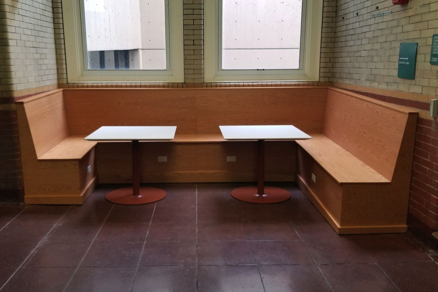 An updated Nook with wooden booth and white tables in Doherty level 2