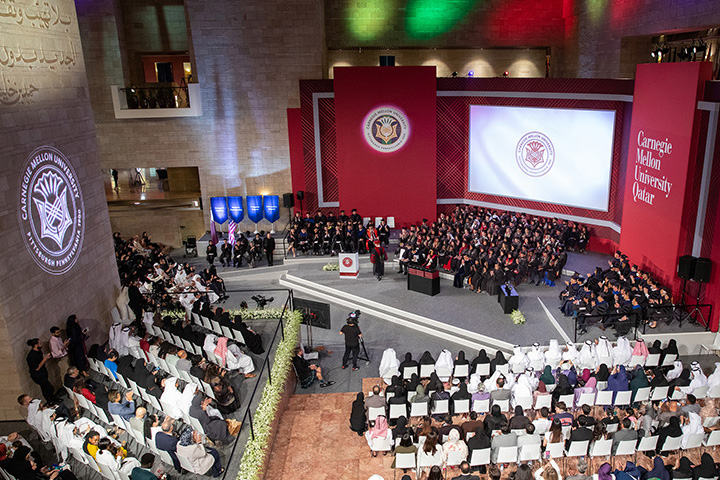 High up angle of a room with graduates on a stage